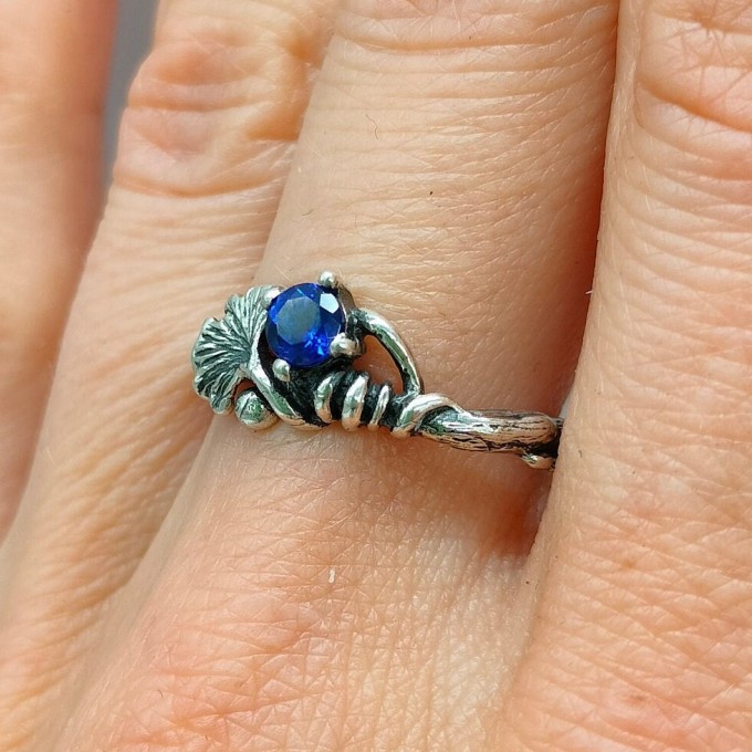 Silver Ring with Sapphire and Intricate Floral Design