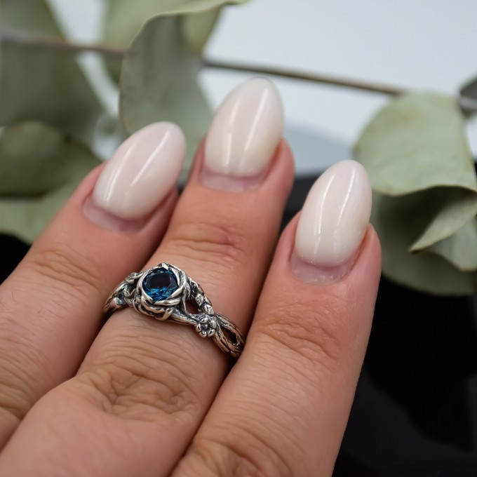 Wings of Serenity: Gothic Sterling Silver Ring with Blue Topaz