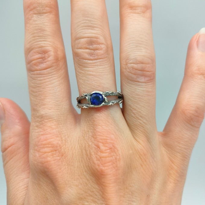 Delicate Silver Band Featuring a Blue Sapphire Gemstone