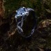 Elegant Silver Ring with Twisting Vines and Emerald Gemstone