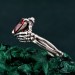 Embrace of Shadows: Gothic Skeleton Hand Garnet Ring