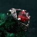 Embrace of Shadows: Gothic Skeleton Hand Garnet Ring