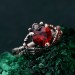 Embrace of Shadows: Gothic Skeleton Hand Garnet Ring