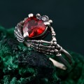 Heart of Shadows: Gothic Skeleton Hand Garnet Ring
